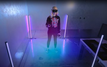 A woman wearing VIVE XR Elite standalone VR headset and playing games